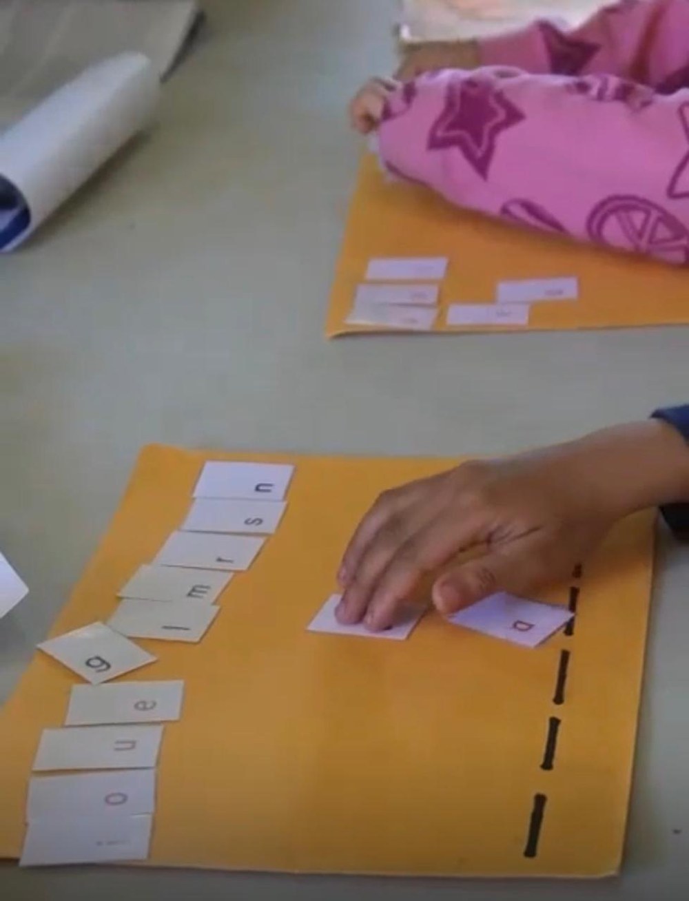 A student blending letter tiles to build words